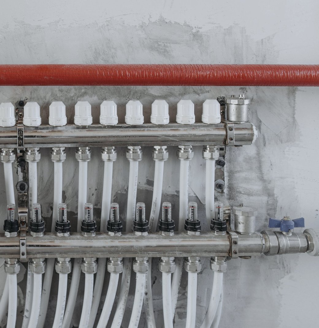 A wall-mounted supply manifold with flow gauges and clean pipe runs.